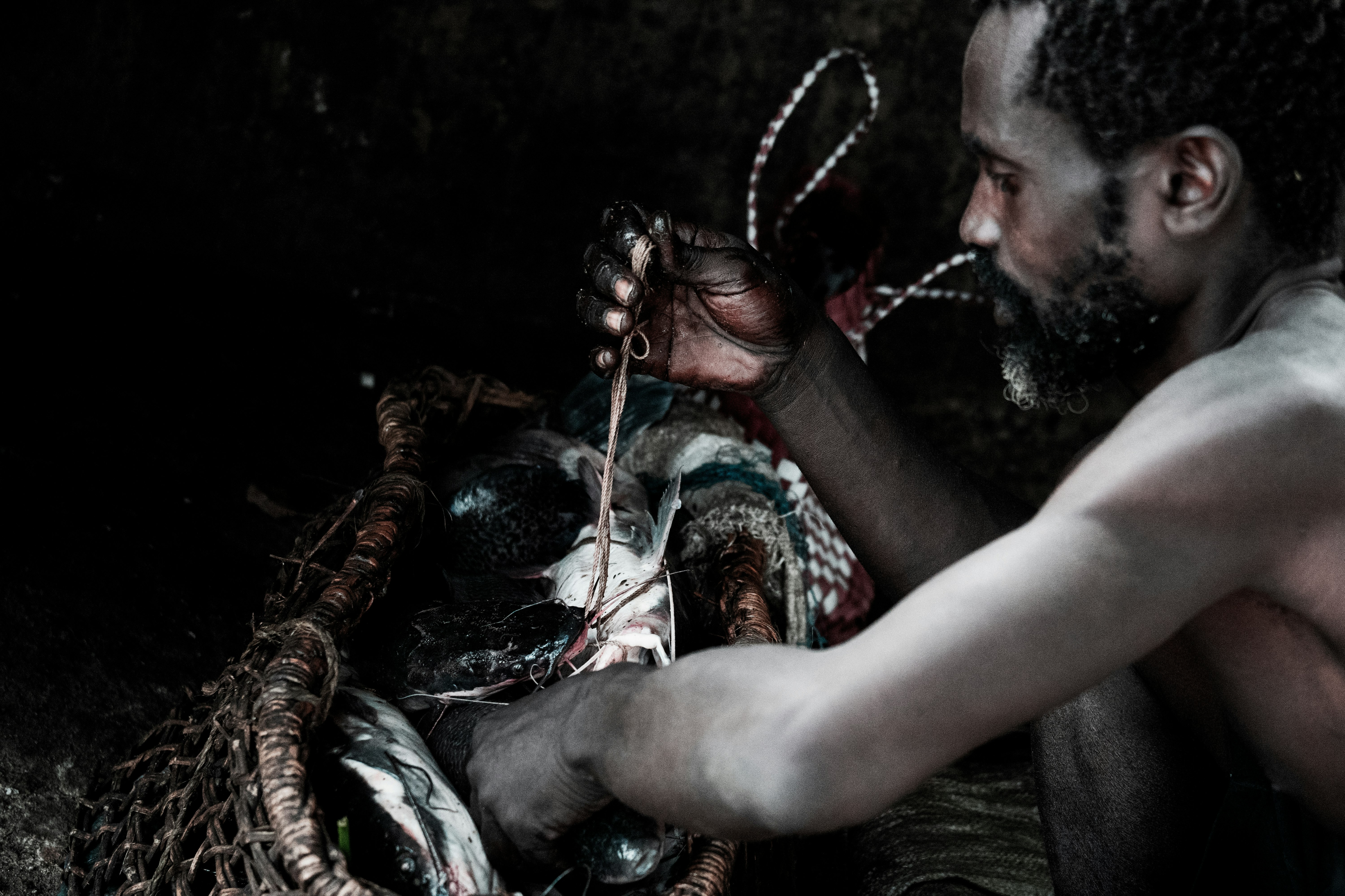 man working on fishing net